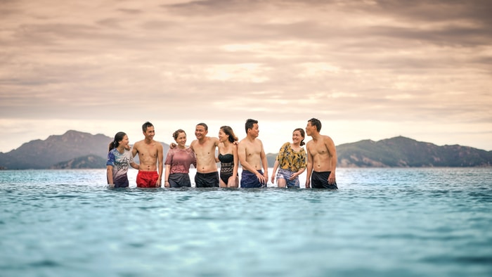 eight person standing in the middle of the sea